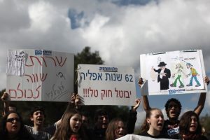 Young Israelis demonstrating outside the Prime Minister's Office in Jerusalem on Sunday, Jan 29, 2012 in protest of the plan to extend the Tal Law which exempts yeshiva students of IDF service. Photo by Kobi Gideon / Flash90 *** Local Caption. Photo courtesy of http://www.jta.org