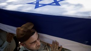 Israeli soldiers carry the coffin of Maj. Tzafrir Bar-Or, 32, one of 13 soldiers who were killed in several separate incidents in Shejaiya on Sunday, at the military cemetery in Holon, Monday, July 21, 2014. . (Photo credit: AP/Dan Balilty)