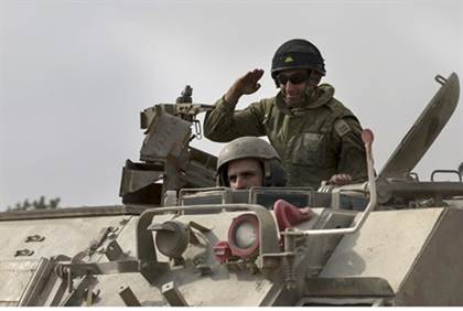 IDF soldiers in an armored personnel carrier near the Gaza border (7 July 2013) Reuters