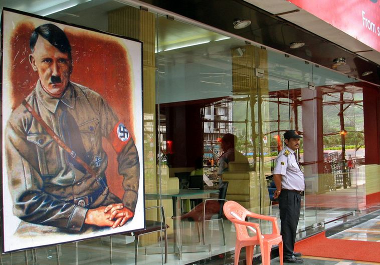 A security personnel stands guard outside a new restaurant, named after Adolf Hitler in Mumbai, India.. (photo credit:REUTERS)